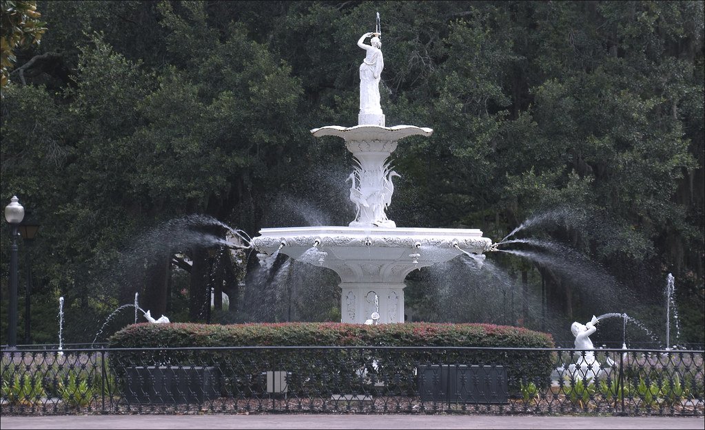 Parco urbano con alberi e fontana in un quartiere residenziale verde