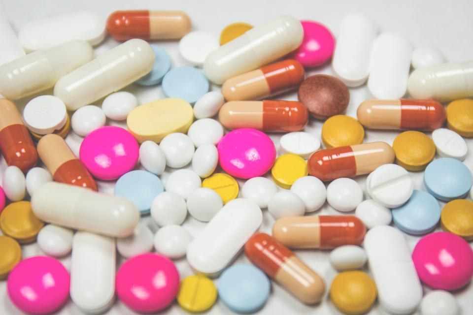 Pillole e farmaci su una superficie, tema spesa sanitaria